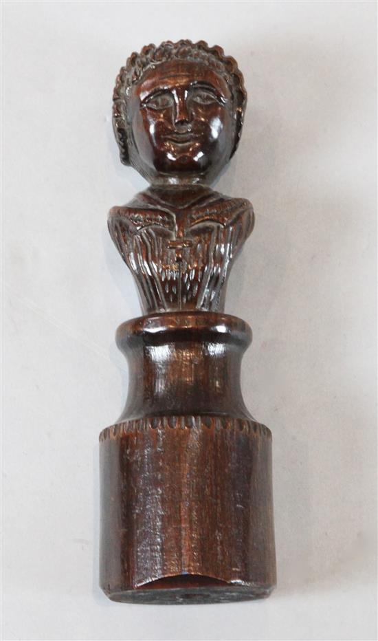 A 17th century carved oak newel post finial of a woman, 11in.